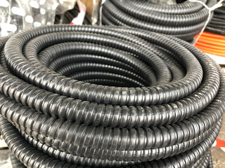 black coiled corrugated insulation tube at warehouse