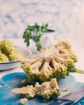 Kitchen table where they are preparing broccoli of the romanescu variety.