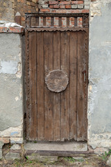 Atique vintage back door made and decorated with weathered wood logs.