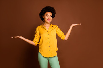 Photo of beautiful business dark skin curly lady holding open palms prefer one best variant...