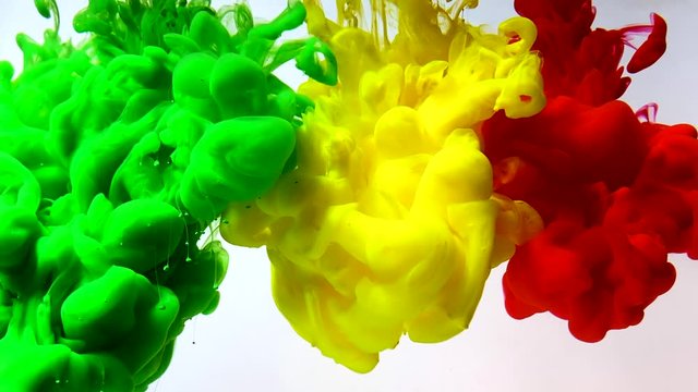 Flag of Mali made of colored ink on a white background. Green, yellow and red watercolor ink in water. Stylish abstract modern background. A powerful explosion of colors. Cool trending screensaver.