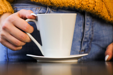 hands holding cup of coffee
