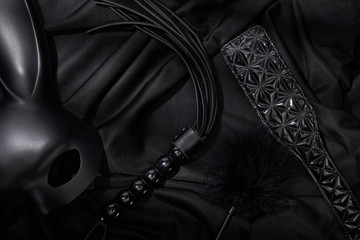 top view of sex toys on black textile background