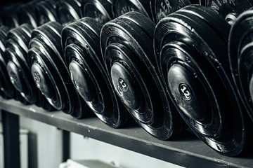 Sports equipment in gym. Dumbbells of different weight close up