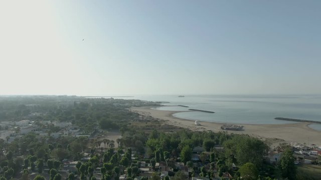 Aerial shooting of a sand seashore with a south city in the background