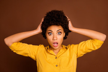 Closeup photo of beautiful pretty dark skin curly lady hold arms on head stressed need to work at weekend bad awful news stupor wear yellow shirt isolated brown color background