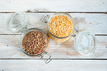 Chickpeas and peas in a glass jar on a wooden table. The concept of diet and healthy eating. Healthy food (cereal).