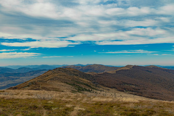 Carpathian Mountains top view landscape ridge autumn season dramatic weather time with cloudy blue sky background