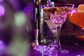 Cocktail drinks with ice in club lights