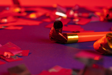 Close up of a party whistle on a purple background