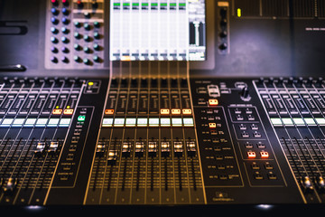 Professional sound and audio mixer control panel with buttons and sliders