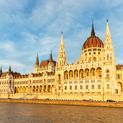 view from the Danube to the famous building of the Hungarian parliament against a beautiful blue sky