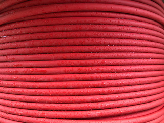 red coiled electrical cable on the wooden spool
