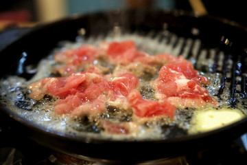 fried fresh meat in iron pan with butter boil oil