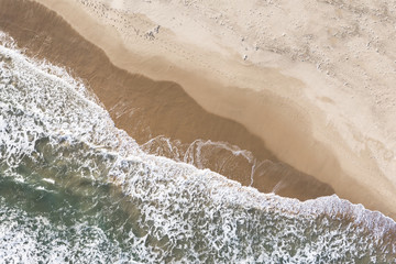 Fototapeta na wymiar Aerial view of big ocean waves crashing on the beach