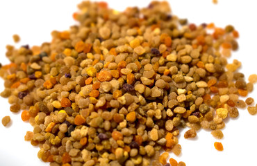 From the work of bees- pollen granules on the white background