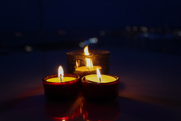 Three lit candles create a romantic atmosphere