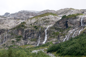 From the cloudy haze the summit peaks - Sofia. On the slopes descend Sofia waterfalls, originating from.
