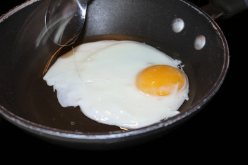 Fried egg. A close up of an egg frying in a pan