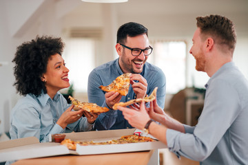 Business team eating pizza and having fun.