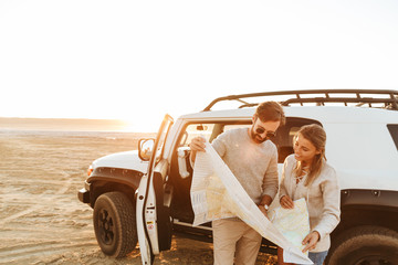 Attractive young couple looking at the travel map