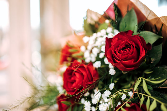 Close-up image of a flower bouquet with red roses, copy space.