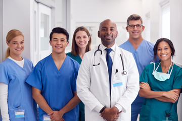 Portrait Of Multi-Cultural Medical Team Standing In Hospital Corridor