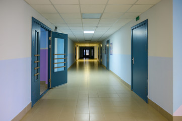 Photo of a corridor in a building with doors