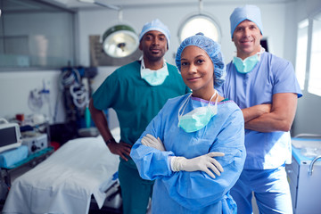 Portrait Of Multi-Cultural Surgical Team Standing In Hospital Operating Theater - obrazy, fototapety, plakaty