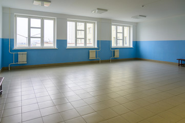 Photo of a room and a corridor in a building with windows