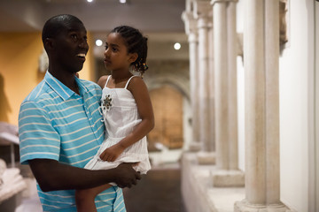 Man and his daughter visiting Art Museum
