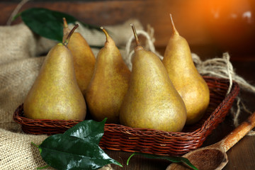 group of ripe pears lie on old planed wooden boards.