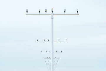 Close-up of parts of the approach lighting system of an airport in front of the runway during day...