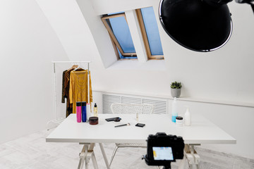 The place of work of a beauty blogger. A light white room. Lighting, camera on tripod.