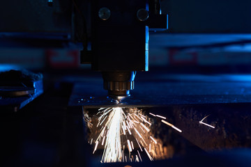 CNC Laser cutting of metal close up, modern industrial technology. Small depth of field