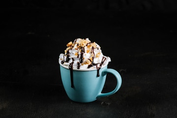 Cup with coffee and creams on black background