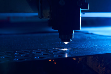 CNC Laser cutting of metal close up, modern industrial technology. Small depth of field