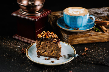Chocolate cake with nuts in composition with coffee drinks on black background