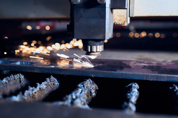 CNC Laser cutting of metal close up, modern industrial technology. Small depth of field