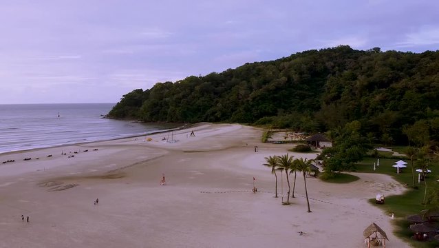 Sunset on a long white sandy beach beside the resort - Drone View - Kota Kinabalu, Sabah, Malaysia