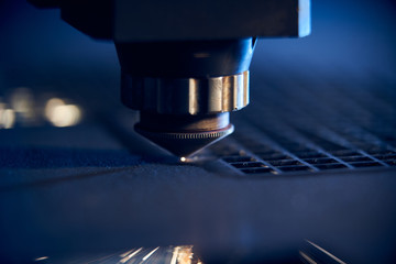 CNC Laser cutting of metal close up, modern industrial technology. Small depth of field