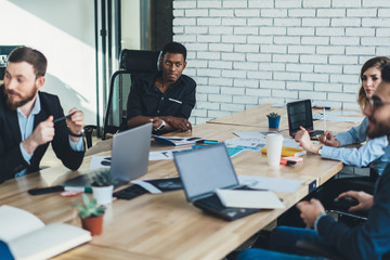 Manager cooperating with partners during business meeting