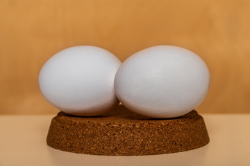 perfect white chicken eggs on a brown background