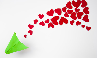 Valentine's Day background. Paper plane with red heart flying on a white background. Greeting card