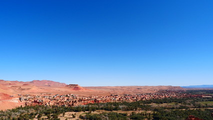 Bright landscape of Morocco, breathtaking curves of mountains, stunning combination of hills & farm land,inadvertent distribution of houses & huts, raw impression of pure nature.