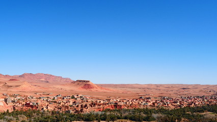 Bright landscape of Morocco, breathtaking curves of mountains, stunning combination of hills & farm land,inadvertent distribution of houses & huts, raw impression of pure nature.
