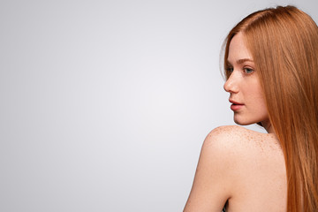 Attractive ginger female with freckled shoulder