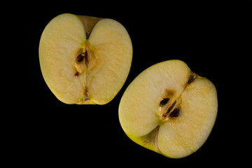 Apple cut in half, on black background