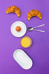Fun breakfast concept with abstract smiling, happy human face made of breakfast items on purple background.