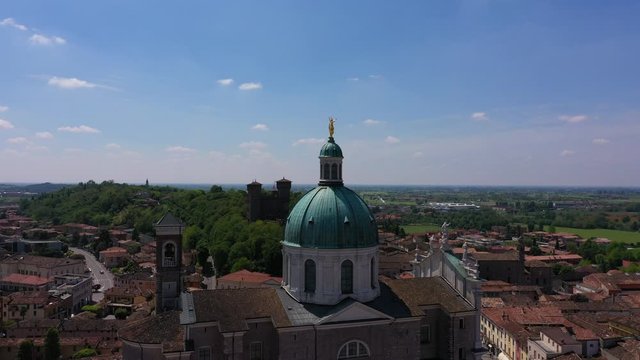 Flying over the Parish of Santa Maria Assunta, Montichiari, Italy. Blue sky. Aerial view